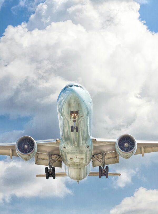 gray and white airplane on flight near clear blue sky